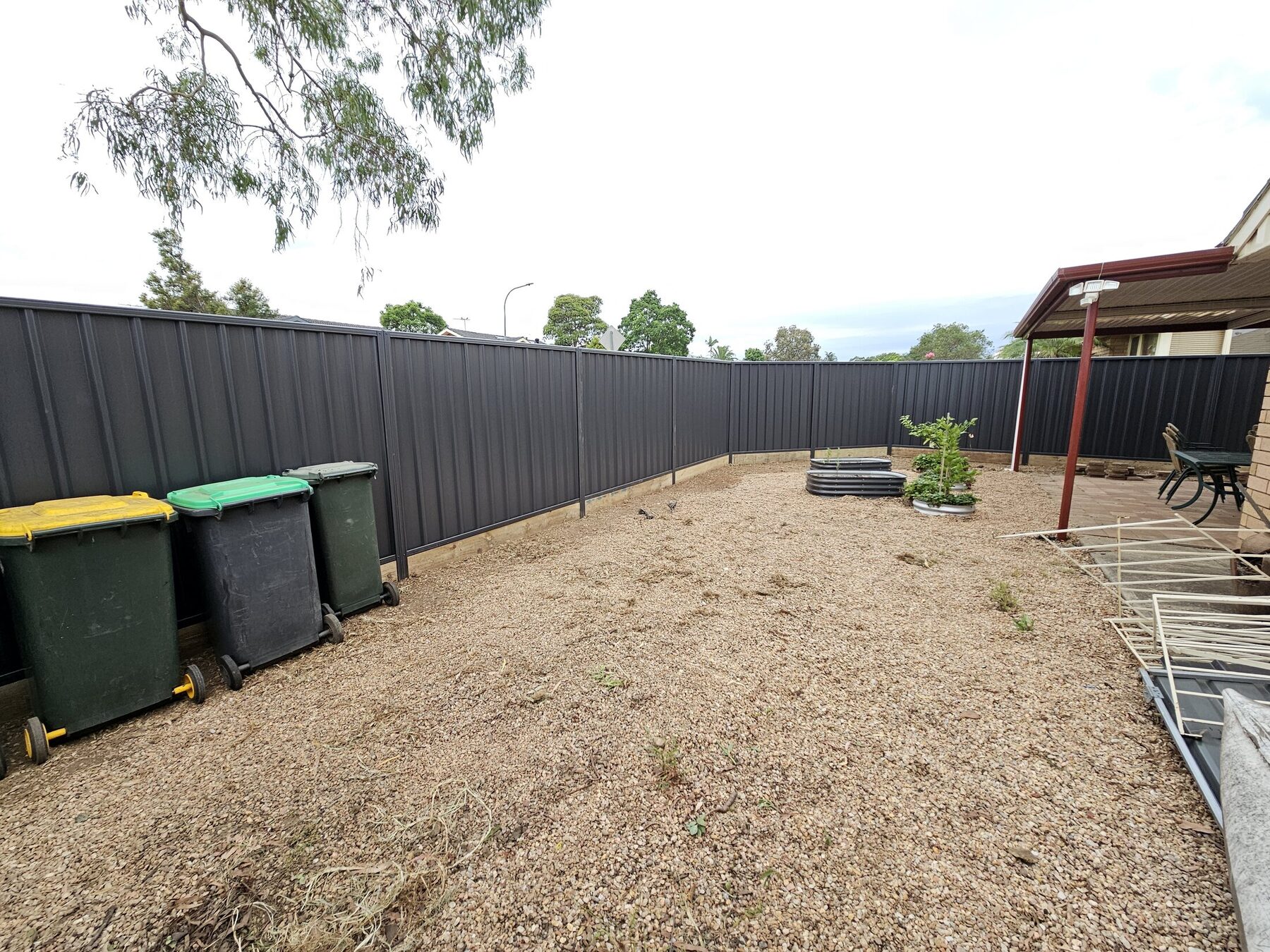 Completed charcoal Colorbond residential boundary fence