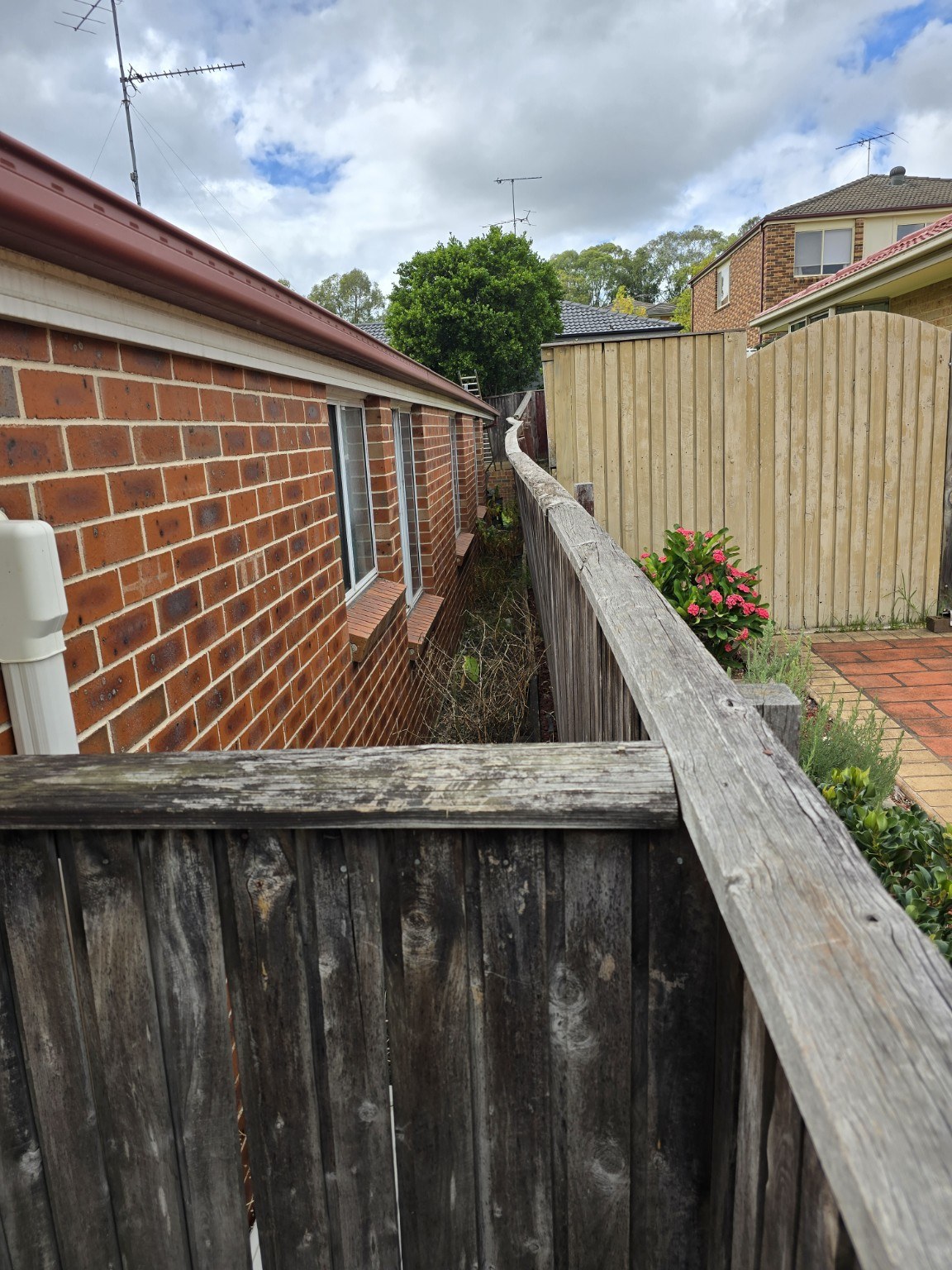 Failed wall and fence beside the neighbouring building